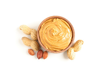 Creamy peanut butter in glass bowl and peanut isolated on white background, top view. A traditional product of American cuisine