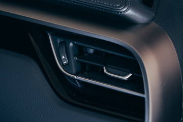 Obraz na płótnie Canvas Car conditioner. The air flow inside the car. Detail interior. Air ducts, deflectors on the car panel
