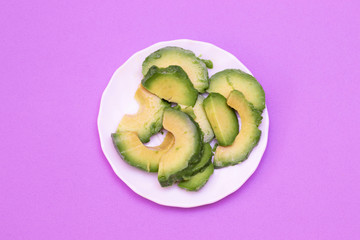 Avocado, cut into pieces on a plate