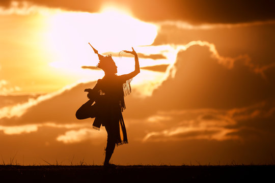 silhouette thai women dance with beautiful sunset and manora thailand