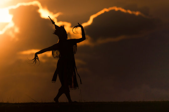 silhouette thai women dance with beautiful sunset and manora thailand