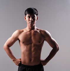 Fototapeta premium The handsome man show body muscle,from exercise,looking straight,good health,blurry light around