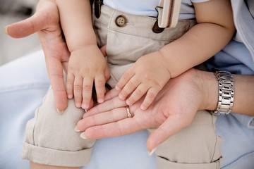 women's hands hold children's hands, mom and child