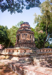 Fototapeta na wymiar Ruins of Animisa Chedi, surrounded by trees. In Chiang Mai, Thailand.
