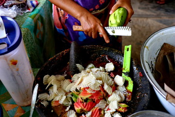 shaved rujak. Indonesian fruit salad with hot spicy sauce. the process of making from kneading spices, until served