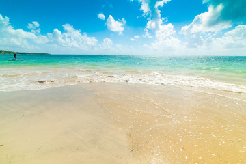 Man paddling over a surfboard in Guadeloupe