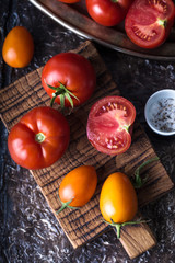 Still life of ripe tomatoes on wooden board