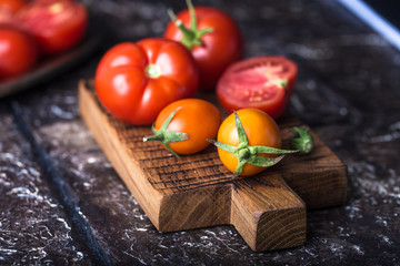 Still life of ripe tomatoes on wooden board