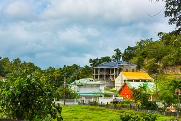 Colorful houses under a cloudy sky in Guadeloupe countryside