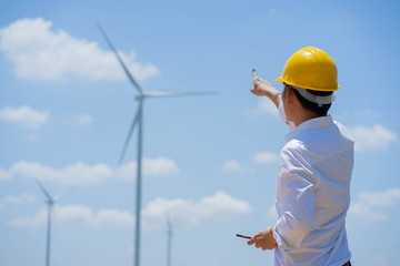 Portrait of Engineers windmills are working on smartphone.