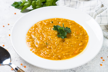 Red lentil soup on white top view.