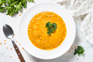 Red lentil soup on white top view.