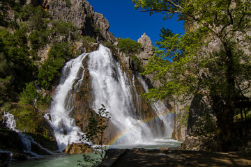 Obraz premium Between the mountain , the great waterfall flowing in the canyon