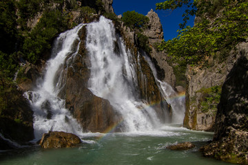 Between the mountain , the great waterfall flowing in the canyon