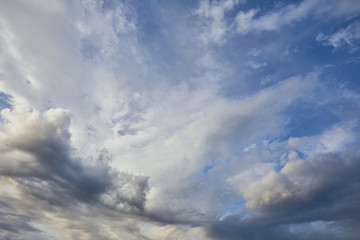 Naklejka na ściany i meble view of grey and white clouds on blue sky background