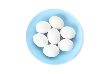 White chicken eggs in plate isolated on white background, top view