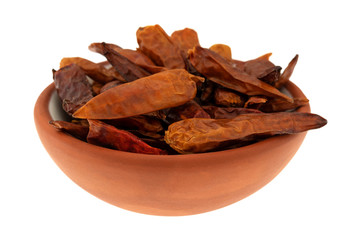 Bowl filled with dried Vietnamese chili peppers on a white background
