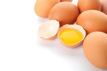 Chicken eggs and half broken egg with yolk  isolated on white background, closeup