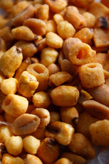Golden mixed nuts, snacks, chips for beer close-up with selective focus.