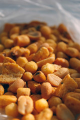 Golden mixed nuts, snacks, chips for beer close-up with selective focus.