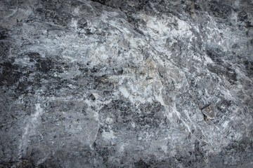 Fototapeta na wymiar Dark textured stone surface