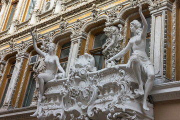Odessa, Ukraine: balcony sculptures, passage - old covered mall and architectural monument.