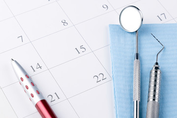 Reminder dentist appointment in calendar pen and professional dental tools.- Image
