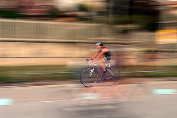 Naklejka premium bicycle on the road,race,speed,cyclist,motion,competition,fast,cycle,blur