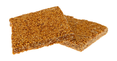 Pieces of sesame seed crunch on a white background side view