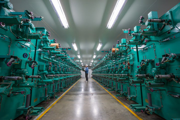 Engineer checking quality the rope kevlar fiber on process production line in the industrial factory