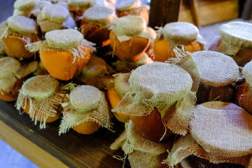Jars of honey with a tied cloth lid