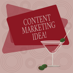Writing note showing Content Marketing Idea. Business photo showcasing focused on creating and distributing valuable content Filled Cocktail Wine Glass with Olive on the Rim Text Space
