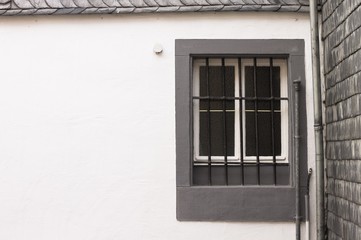 Isolated grey window in a white wall background (Bacharach, Germany, Europe)