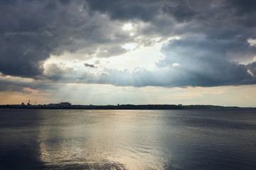 River coastline, overcast weather and clouds with sunlight