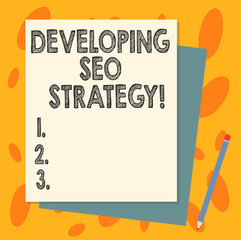 Handwriting text Developing Seo Strategy. Concept meaning process of tailoring your website at optimal rank Stack of Blank Different Pastel Color Construction Bond Paper and Pencil