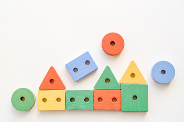 Wooden houses is made of toy blocks on a white background