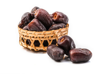 dates in basket isolated on white background