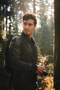 man holding black DSLR camera