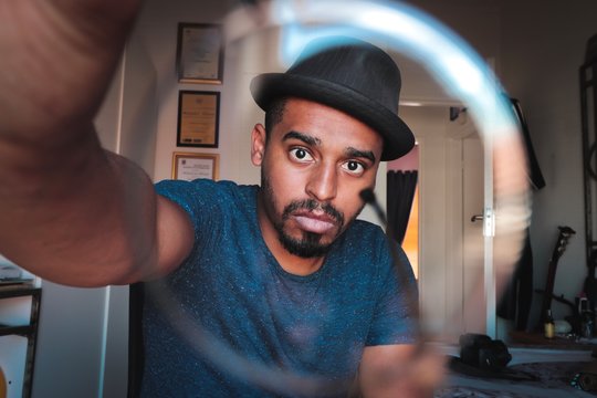 man wearing black hat in room