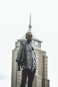 man wearing gray leather jacket