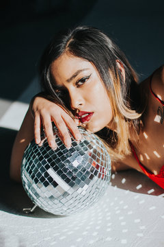 woman holding disco ball