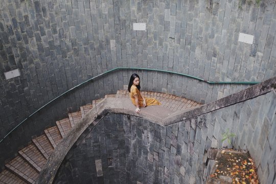woman sitting on stair raillings