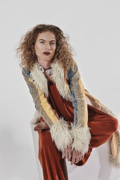 woman sitting while wearing coat