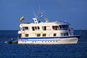 Naklejka premium Typical tourist yacht anchored at Suarez Point at Espanola Island, Galapagos National park, Ecuador
