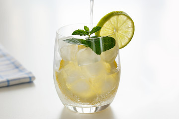 Mineral water with lemon in a steaming glass