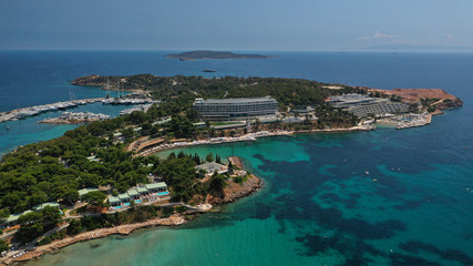 Fototapeta na wymiar Aerial drone bird's eye panoramic photo of famous celebrity sandy beach of Astir or Asteras in south Athens riviera with turquoise clear waters, Vouliagmeni, Greece