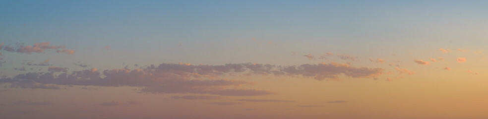 Cloudscape panorama, blue orange soft colors, copy space