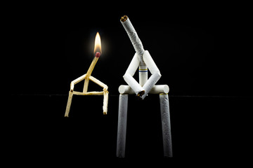 image of a character made of cigarette, alone and sad with black background. Concept of addiction...