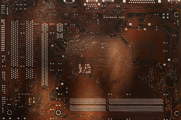Printed brown computer circuit board. Close up. Circuit board background.