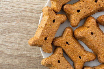 Top close view of peanut butter dog biscuits on a white plate